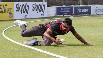 UAE player Chirag Suri attempts to save a boundary during the Cricket World Cup League 2 match at the ICC Academy in Dubai.