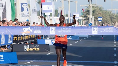 Marius Kipserem begins to celebrate as he crosses the finish line to win the Adnoc Abu Dhabi Marathon. Leslie Pableo for The National