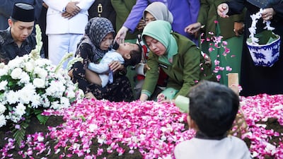 Relatives next to the grave of Farizal Rhomadhon, a UN Interim Force Lebanon peacekeeper, killed in Lebanon, during a funeral ceremony in Yogyakarta, Indonesia. Reuters