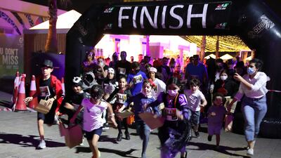 Children cross the finish line at the one-of-a-kind Halloween Run