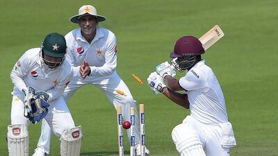 West Indies' batsman Leon Johnson, right, is bowled out during the fourth day of the second Test against Pakistan on Monday. Aamir Qureshi / AFP / October 24, 2016