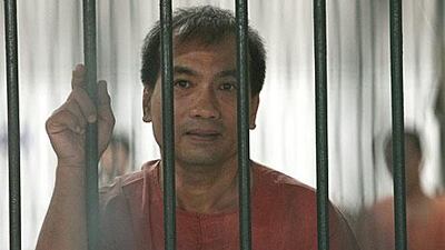 Joe Gordon, a Thai-born US citizen, looks on from his prison cell. Mr Gordon was sentenced to two and a half years in jail for translating and positing online The King Never Smiles, a biography banned in Thailand.