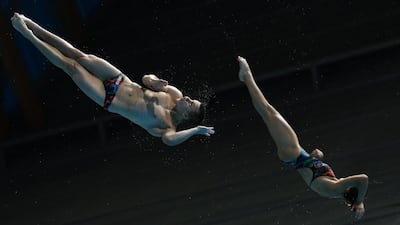 Russian divers Maria Polyakova, right, and Ilia Molchanov compete during the diving mixed 3m synchro springboard final at the World Aquatics Championships on Sunday. Valdrin Xhemaj / EPA