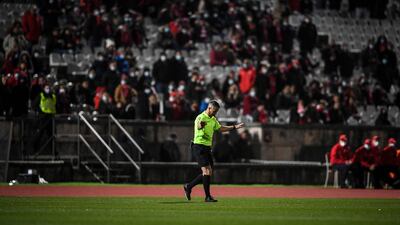 Portuguese referee Manuel Mota blows his whistle to finish the match at the start of the second half. AFP