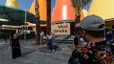 World's fair visitors take photos outside the Spain pavilion. Bloomberg