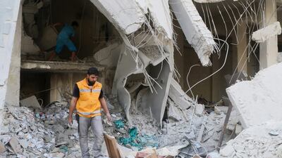 A Red Crescent aid worker inspects scattered medical supplies after an airstrike on a medical depot in the rebel-held Tariq Al Bab neighbourhood of Aleppo, Syria April 30, 2016. REUTERS/Abdalrhman Ismail