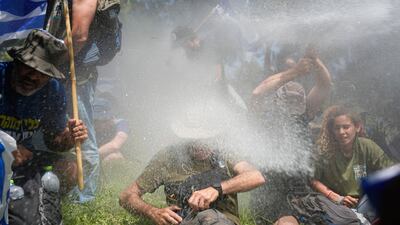 Israeli police use water cannon against demonstrators during a protest against plans to overhaul the judicial system by limiting supreme court powers to review government actions. AP
