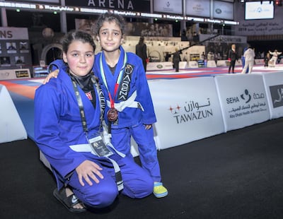 Saudi Arabia's Leena Al Hakeem, left, won a silver medal in the the white belt 75kg for junior girls at the Mubadala Arena. Victor Besa / The National