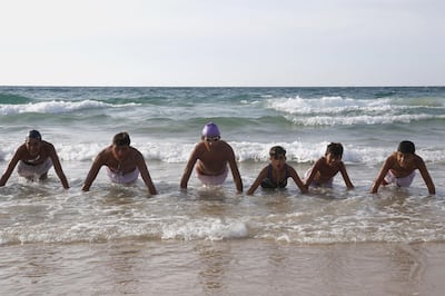 Palestinian children, members of a swimming club, participate in a training session in Beit Lahia in the northern Gaza Strip, on October 4, 2018. On one of the world's most polluted beaches, 30 young Palestinians dive head first into the sea off the coast of Gaza, their minds filled with dreams of Olympic glory. Aged between 11 and 16, they make up a rare swimming club in the Gaza Strip, and perhaps its only mixed-sex one. / AFP / SAID KHATIB