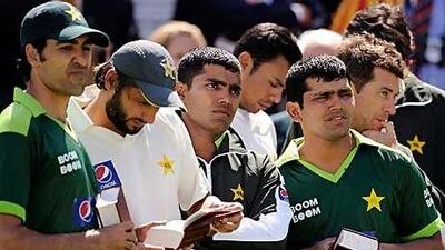 Pakistan's Shahid Afridi, second left, consults a copy of the Wisden Cricketers' Almanack after yesterday's defeat to Australia.