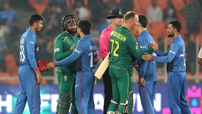 South Africa's Andile Phehlukwayo and Rassie van der Dussen shake hands with Afghanistan players. Reuters