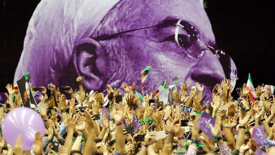 Supporters of Iranian current president and presidential candidate Hassan Rouhani cheer in front of a huge election banner depicting him as they hold his pictures during an election campaign rally in Tehran. Incumbent Rouhani will challenge five other candidates on May 19 for a second term of presidency. Abedin Taherkenareh / EPA