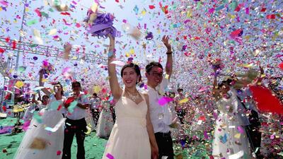 Couples celebrate during a mass wedding ceremony to mark the Qixi Festival in Shenyang, Liaoning province in China on August 2, 2014. According to local media, 77 couples attended the mass wedding on Saturday. Qixi, also known as the Double Seventh Festival and the Chinese version of Valentine’s Day, falls on the seventh day of the seventh month in the Chinese lunar calendar. Reuters