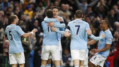 Manchester City's Stevan Jovetic, centre, celebrates scoring the opening goal in his team's FA Cup fifth-round match against Chelsea at the Etihad Stadium on Saturday. Jon Super / AP Photo
