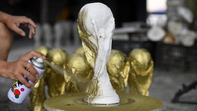 Hand-made plaster models of the 18-carat gold trophy that will go to the winners of the World Cup. Fifa is likely to beat its $5.65bn profit target for this competition despite struggling for sponsors. Nhac Nguyen / AFP