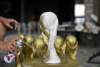 Hand-made plaster models of the 18-carat gold trophy that will go to the winners of the World Cup. Fifa is likely to beat its $5.65bn profit target for this competition despite struggling for sponsors. Nhac Nguyen / AFP