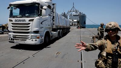 A lorry carries supplies across the Trident Pier, a temporary platform built by the US to deliver aid, near the Gaza coast, in June 2024. Reuters