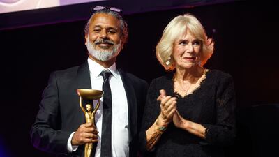 Camilla, Queen Consort presents Shehan Karunatilaka, winner of the Booker Prize 2022, with his trophy at a ceremony at the Roundhouse, London.