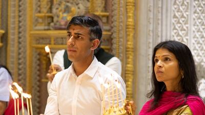 Rishi Sunak and his wife Akshata Murty light candles for an aarti or prayer service at the Swaminarayan Akshardham Hindu temple. Photo: BAPS