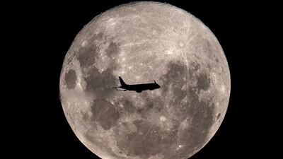 An Embraer 190-100IGW plane of Aerolineas Argentinas, on a regular flight from Buenos Aires to the Argentine city of Bahia Blanca, passes in front of the super moon. AFP