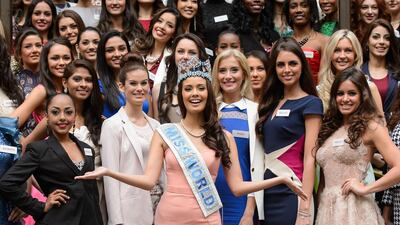 Miss World 2014 contestants, led by the current Miss World; Megan Young from the Philippines, centre, pose for pictures at a photocall. The Miss World contest will be held in London on December 14, 2014. Leon Neal / AFP photo