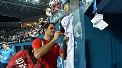 Roger Federer signs autographs on his way out of Pat Rafter Arena following his win in the ATP Brisbane International final on Sunday. Saeed Khan / AFP