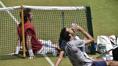 Andy Murray, left, and James Ward rest after a practice session at Wimbledon. Toby Melville / Reuters / July 3, 2015