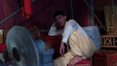 A Chiu Chow opera performer sits in the backstage during a performance. EPA