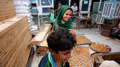 People gather at a bakery in Baghdad, Iraq. AP Photo