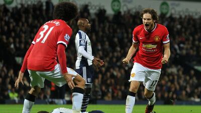 Manchester United's Dutch midfielder Daley Blind, right, celebrates scoring his team's second goal during the English Premier League match against West Bromwich Albion at The Hawthorns in West Bromwich, England, on October 20, 2014. Paul Ellis / AFP