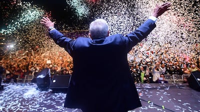 Newly elected Mexico's President Andres Manuel Lopez Obrador (C), running for "Juntos haremos historia" party, cheers his supporters at the Zocalo Square after winning general elections, in Mexico City, on July 1, 2018. Pedro Pardo / AFP