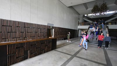 People walk inside the Former cultural and sports centre of the Ministry of the Interior.