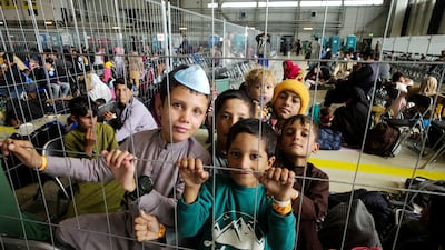 Children from Afghanistan wait to fly to the US or another safe location inside a hangar at the US Air Base in Ramstein, Germany. AP