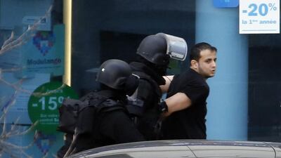 A man, who had taken two hostages in a post office, surrenders to French security forces on January 16 in Colombes, outside Paris. AFP Photo