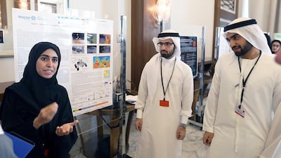 From left, Manar Al Mazrouei, Abdullah Sharif and Adham Al Khaja of the Masdar Institute of Science and Technology talk about their project during the Emirates Mars Mission Workshop in Dubai. Satish Kumar / The National