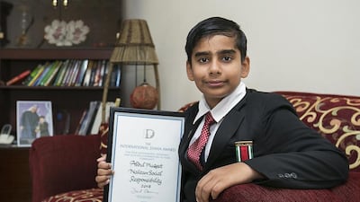 Indian Abdul Muqeet, 12, with his International Diana Award, signed by the prime minister of Britain, David Cameron. The schoolboy was honoured for his environmental work and innovative green thinking. Mona Al Marzooqi / The National
