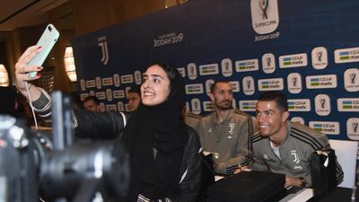 A Saudi fan takes a selfie with Cristiano Ronaldo. Getty Images