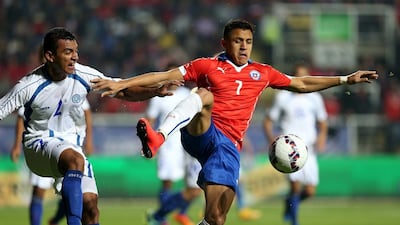 Alexis Sanchez, right, of Chile and Xavier Garcia of El Salvador compete for the ball during a friendly match in Rancagua, south of Santiago city, June 5, 2015. REUTERS/Carlos Parra