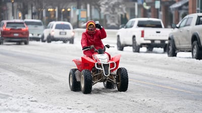 A person operates a four wheeler on Main Street in Greenville, South Carolina. AFP