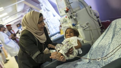 Four-year-old Palestinian Ritag Harami from Bethlehem is lifted by her mother during her kidney dialysis treatment at the Augusta Victoria Hospital on the Mount of Olives in east Jerusalem. All photos by Heidi Levine for The National