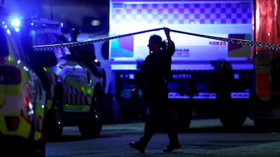 A police officer walks along cordon tape at the scene of a mass shooting at Bondi Beach. Getty Images