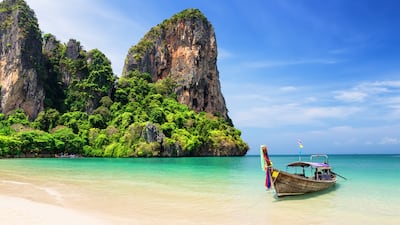 8. Thai traditional wooden longtail boat and beautiful sand at Railay Beach in Krabi province, Thailand.
