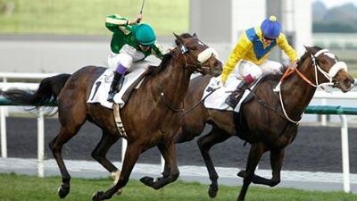 First Lady, ridden by Royston Ffrench, left, closes in Mahooba, Christophe Soumillon.