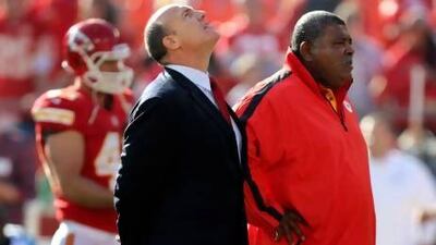 Scott Pioli, Kansas City Chiefs general manager, left, and coach Romeo Crennel stand together before last night's NFL match against the Carolina Panthers at Arrowhead Stadium in Kansas City. The staging of the game divided opinion after the suicide of Chiefs player Jovan Belcher. Ed Zurga / AP Photo
