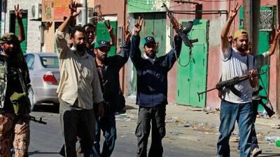 Rebel fighters celebrate after taking partial control of the coastal town of Zawiya, 50km west of Tripoli yesterday. Libyan rebels hoisted their flag in the centre of the town near the capital after their most dramatic advance in months. Bob Strong / Reuters