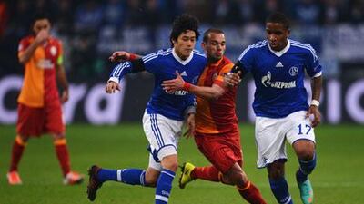 Wesley Sneijder, of Galatasaray, centre, is challenged by Schalke pair Atsuto Uchida and Jefferson Farfan during their Champions League match.