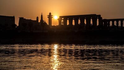 Sun rising behind the Luxor Temple and the River Nile in the southern Egyptian town of Luxor. Acwa Power's scheme will instal 2,300MW capacity in the town. AFP