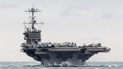 The aircraft carrier USS Harry S Truman transits the Strait of Hormuz on December 26. J Lieberknecht / US Navy via AP