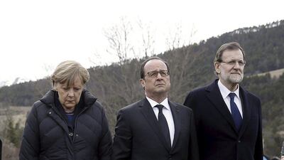 From left to right; the German chancellor, Angela Merkel, France's president, Francois Hollande, and Spain's prime minister, Mariano Rajoy, walk on a field near the crash site of Germanwings Airbus A320 near Seyne-les-Alpes. Diego Crespo / Reutes