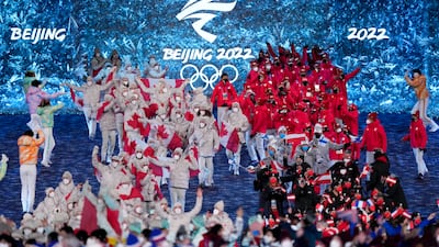Team Canada, left, and Team Japan arrive during the closing ceremony. AP